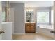 The main bathroom features a soaking tub, wood cabinetry, and tiled floors at 4765 Silver Leaf Dr, Cumming, GA 30040