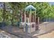 Community playground with a slide and climbing structure surrounded by trees at 4765 Silver Leaf Dr, Cumming, GA 30040
