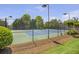 Community tennis court surrounded by a fence and green landscaping at 4765 Silver Leaf Dr, Cumming, GA 30040