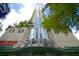 Exterior shot of the building featuring the spire, multiple floors, and recognizable restaurant at 860 Peachtree Ne St # 1411, Atlanta, GA 30308