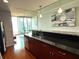 Modern kitchen with black countertops, wooden cabinets and stainless steel appliances at 860 Peachtree Ne St # 1411, Atlanta, GA 30308