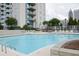 Community pool area featuring lounge chairs for residents to relax and soak up the sun at 860 Peachtree Ne St # 1411, Atlanta, GA 30308