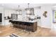 Modern kitchen with stainless steel appliances, large center island with seating, and stylish pendant lights at 1248 Windmill Pkwy # 240, Cumming, GA 30041