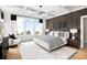 Beautiful main bedroom with coffered ceiling, wood accent wall, and large windows at 1248 Windmill Pkwy # 240, Cumming, GA 30041