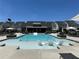 Resort-style community pool with tanning ledge, lounge chairs, and nearby houses at 1248 Windmill Pkwy # 240, Cumming, GA 30041