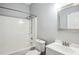 Bright bathroom with white tub and shower combination, gray walls, and updated vanity at 65 Wisteria Blvd, Covington, GA 30016