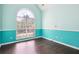 Bedroom featuring hardwood floors and a large arched window that fills the room with lots of natural light at 65 Wisteria Blvd, Covington, GA 30016
