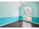 Bedroom featuring hardwood floors and a large arched window that fills the room with lots of natural light at 65 Wisteria Blvd, Covington, GA 30016