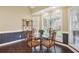 Dining area with large window, ornate chairs and glass table in a neutrally decorated room at 65 Wisteria Blvd, Covington, GA 30016