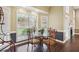 Dining area with large window, ornate chairs and glass table in a neutrally decorated room at 65 Wisteria Blvd, Covington, GA 30016