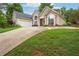 Well-maintained home showcasing a manicured lawn, mature trees, and a long driveway, enhancing its curb appeal at 65 Wisteria Blvd, Covington, GA 30016