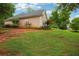 Side view of a home with an expansive yard and well-maintained landscaping at 65 Wisteria Blvd, Covington, GA 30016