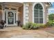 Charming home entrance featuring a decorative door, manicured landscaping, and inviting curb appeal at 65 Wisteria Blvd, Covington, GA 30016
