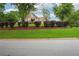 Well-maintained front yard showcasing lush greenery, mature trees, and tidy landscaping at 65 Wisteria Blvd, Covington, GA 30016