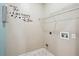Essential laundry room with a clean aesthetic, equipped with hookups and shelving for storage at 65 Wisteria Blvd, Covington, GA 30016