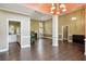 Open-concept living area with hardwood floors, high ceilings, and seamless flow into the kitchen and dining at 65 Wisteria Blvd, Covington, GA 30016
