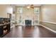 Spacious living room with a fireplace, high ceilings, wood floors, and lots of natural light at 65 Wisteria Blvd, Covington, GA 30016