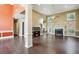 Spacious living area boasts an open floorplan, hardwood floors, fireplace, and seamless access to the kitchen at 65 Wisteria Blvd, Covington, GA 30016