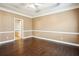 A primary bedroom with rich hardwood floors and an ensuite bathroom at 65 Wisteria Blvd, Covington, GA 30016
