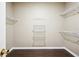Spacious walk-in closet featuring hardwood floors and convenient wire shelving for optimal storage and organization at 65 Wisteria Blvd, Covington, GA 30016