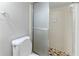 Bathroom featuring tiled shower with glass door, toilet, and neutral wall color at 6595 Oakwood Dr, Douglasville, GA 30135