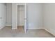 Neutral bedroom showing open closet and bedroom doors with wall to wall carpet at 6595 Oakwood Dr, Douglasville, GA 30135
