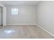 An empty bedroom showing neutral walls, carpet, and a window with open closet at 6595 Oakwood Dr, Douglasville, GA 30135