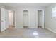 Spacious bedroom featuring neutral carpet, and multiple closets with doors open at 6595 Oakwood Dr, Douglasville, GA 30135