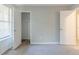 A bright bedroom with neutral walls and carpet, showing closet and interior doors at 6595 Oakwood Dr, Douglasville, GA 30135
