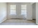 Bright bedroom with neutral carpet, closet, and natural light from two windows at 6595 Oakwood Dr, Douglasville, GA 30135