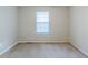 Empty bedroom with neutral walls and carpet, featuring a single window with blinds at 6595 Oakwood Dr, Douglasville, GA 30135