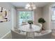Charming dining area with stylish round table, chairs and serene view to backyard deck at 6595 Oakwood Dr, Douglasville, GA 30135