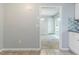 View from the kitchen into the dining area featuring a sliding door to the porch and modern light fixture at 6595 Oakwood Dr, Douglasville, GA 30135