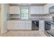 Bright and functional kitchen with ample countertop space, white cabinets, and modern appliances at 6595 Oakwood Dr, Douglasville, GA 30135