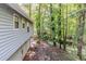 Side view of house and yard featuring siding, many trees, and a concrete walkway at 6595 Oakwood Dr, Douglasville, GA 30135