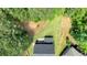 An aerial view showcases the property's layout, roof, landscaping, and the surrounding greenery at 209 Wildwood Way, Canton, GA 30114