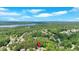 Aerial view showcases neighborhood with lake views surrounded by green trees and blue skies at 209 Wildwood Way, Canton, GA 30114