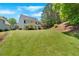 Expansive backyard features lush lawn, covered patio, and ample space for outdoor activities and entertaining at 209 Wildwood Way, Canton, GA 30114