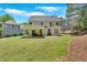 Expansive backyard showcasing a covered patio, lush lawn, and mature trees at 209 Wildwood Way, Canton, GA 30114