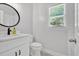 Bathroom with a white vanity, tile floors, and a framed mirror at 209 Wildwood Way, Canton, GA 30114