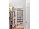 Organized walk-in closet featuring shelves and hanging storage for clothes and shoes at 209 Wildwood Way, Canton, GA 30114