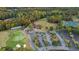 Aerial view of the neighborhood's golf course, clubhouse, tennis courts and surrounding green space at 209 Wildwood Way, Canton, GA 30114