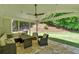 Cozy covered patio with stone flooring, seating, and a ceiling fan for relaxing outdoors at 209 Wildwood Way, Canton, GA 30114