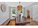 Dining room featuring wood table, chandelier, hardwood floors, and lots of light at 209 Wildwood Way, Canton, GA 30114