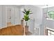 Hallway featuring hardwood floors, a staircase, and a view of the entryway at 209 Wildwood Way, Canton, GA 30114