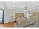 Spacious main bedroom with tray ceilings, hardwood floors, and elegant decor, exuding comfort and style at 209 Wildwood Way, Canton, GA 30114