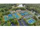 Aerial view of the neighborhood's many outdoor tennis courts surrounded by green trees and green space at 209 Wildwood Way, Canton, GA 30114