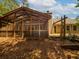 View of the house backyard with the screened-in porch and wooden deck attached at 3177 Westfield Ne Way, Roswell, GA 30075