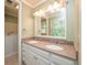 Bright bathroom featuring double sinks with a granite countertop and framed mirror at 3177 Westfield Ne Way, Roswell, GA 30075