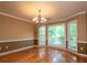 Bright dining room featuring chandelier lighting, hardwood floors and large windows at 3177 Westfield Ne Way, Roswell, GA 30075
